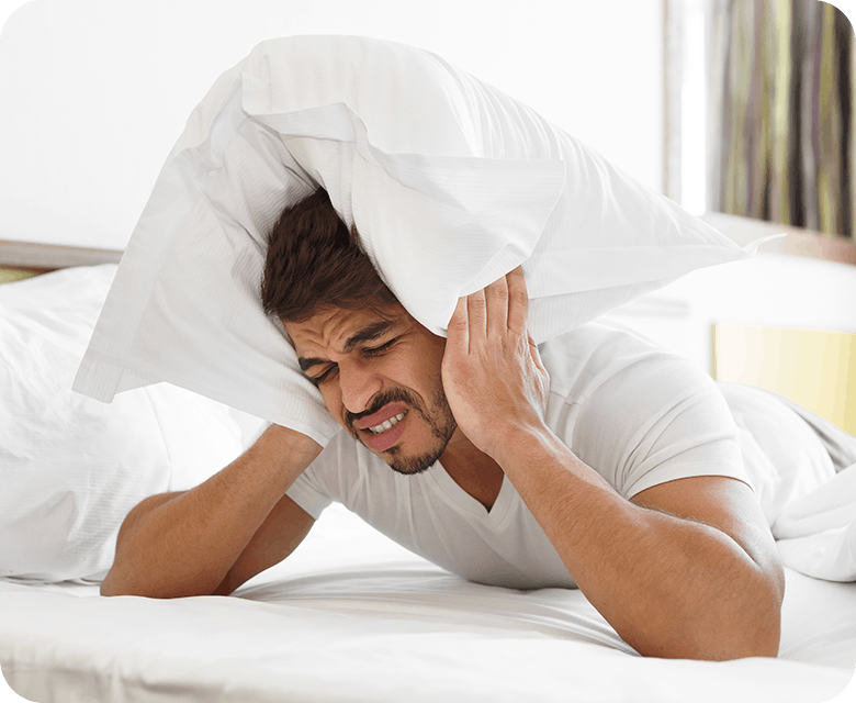 Man In Bed Having A Migraine