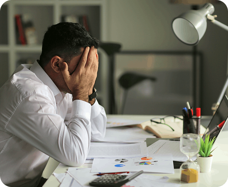 Man Having A Headache While Working On Desk