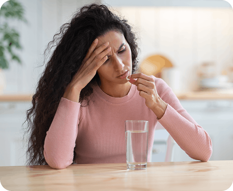 Woman With Headache Taking Panadol Tablets