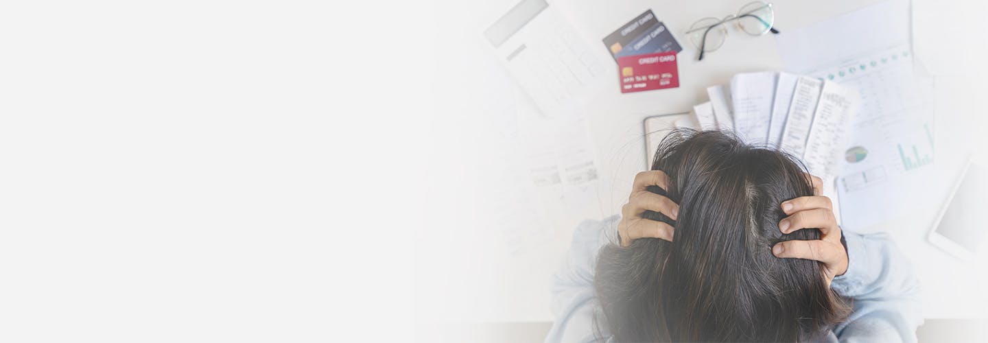 stressed young woman calculating and holding her head