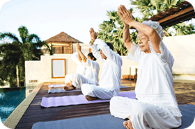 Group of seniors practicing yoga in the morning