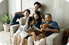 Happy japanese family on the couch laughing