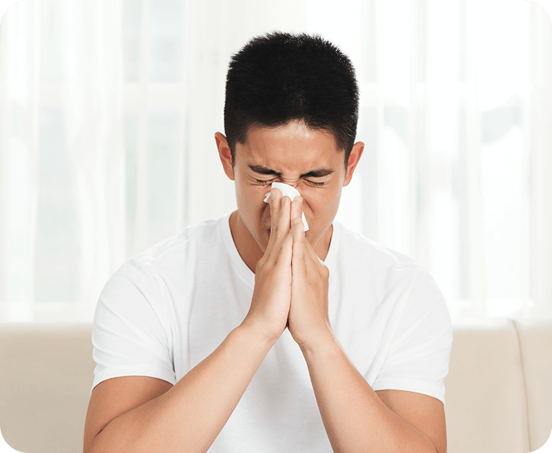 young mixed race man using paper tissue