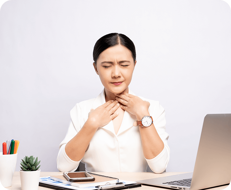 Asian woman in the office holding her throat