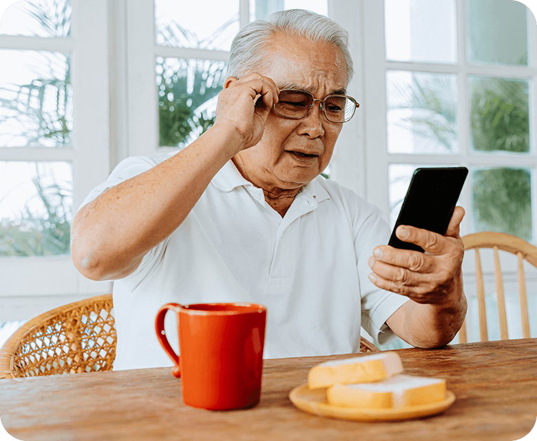 elderly asian male having eyesight problems