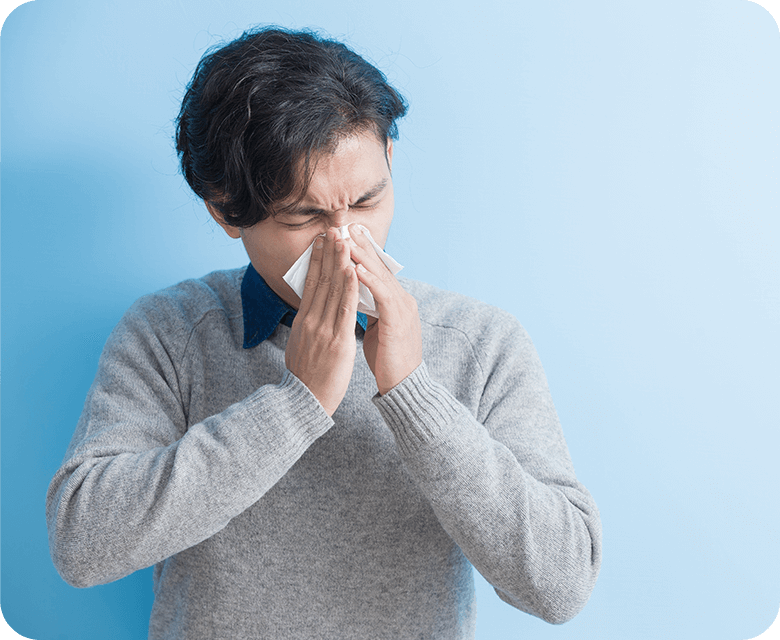 asian man blowing his nose