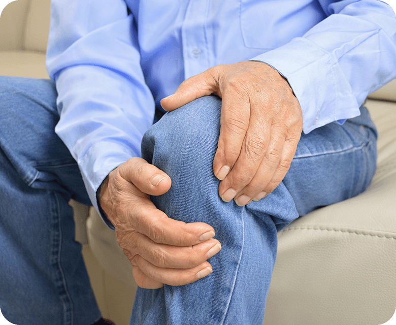 elderly person holding his knee