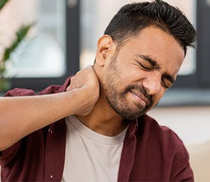 a man dealing with neck pain