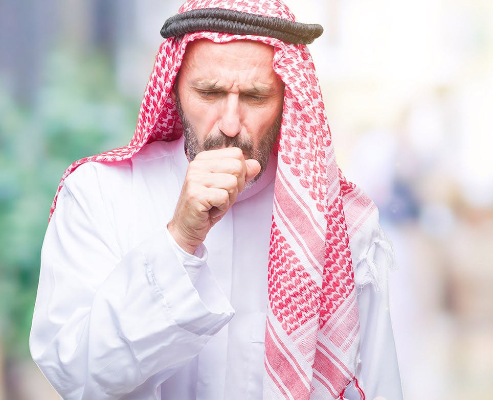 A man coughing and suffering from body aches A man coughing and suffering from body aches