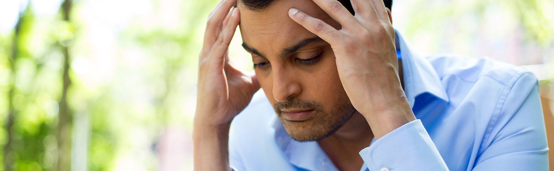 A man suffering from a headache A man suffering from a headache