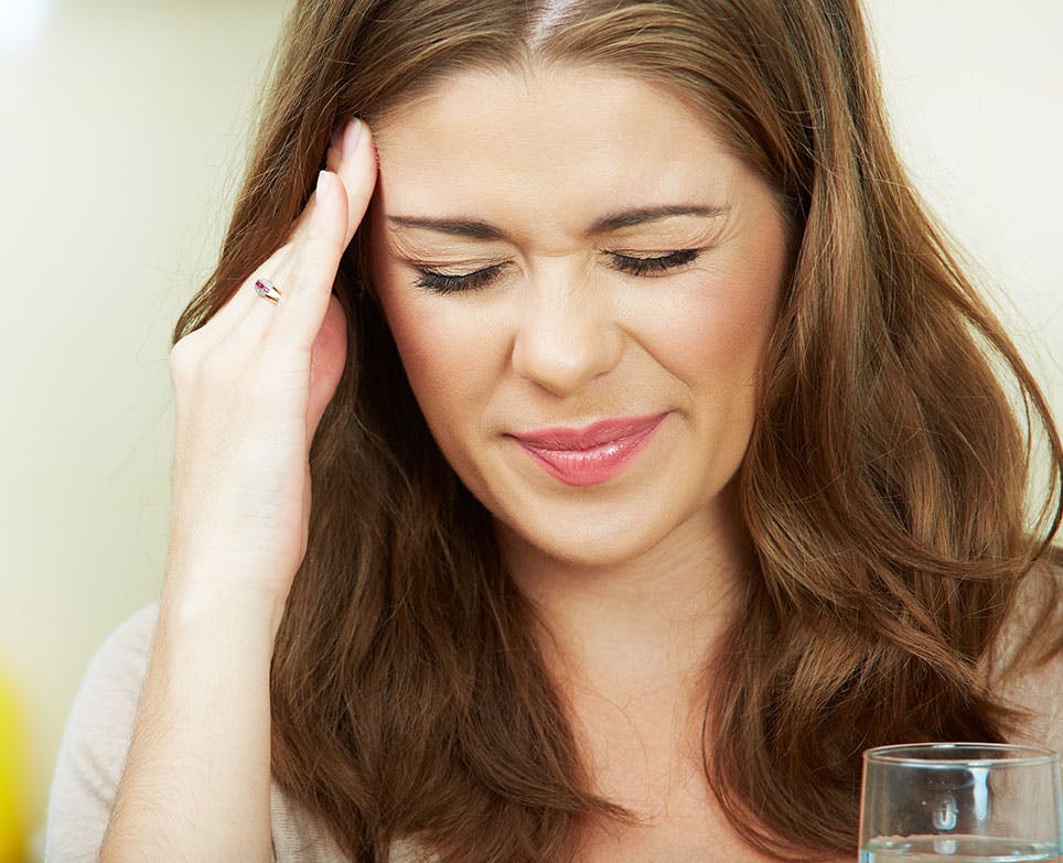 A woman dealing with a headache A woman dealing with a headache