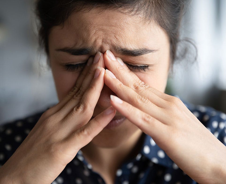 A woman dealing with a painful headache A woman dealing with a painful headache
