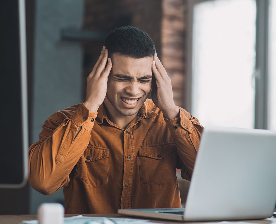 A hardworking man dealing with a massive headache A hardworking man dealing with a massive headache