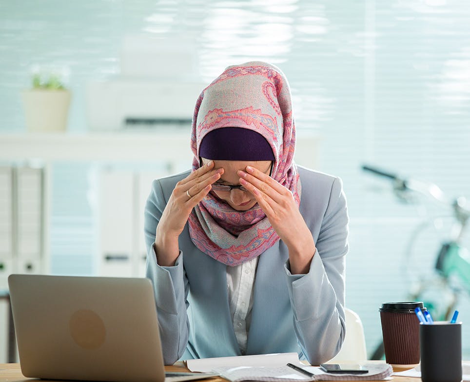 A working woman dealing with an intense headache A working woman dealing with an intense headache