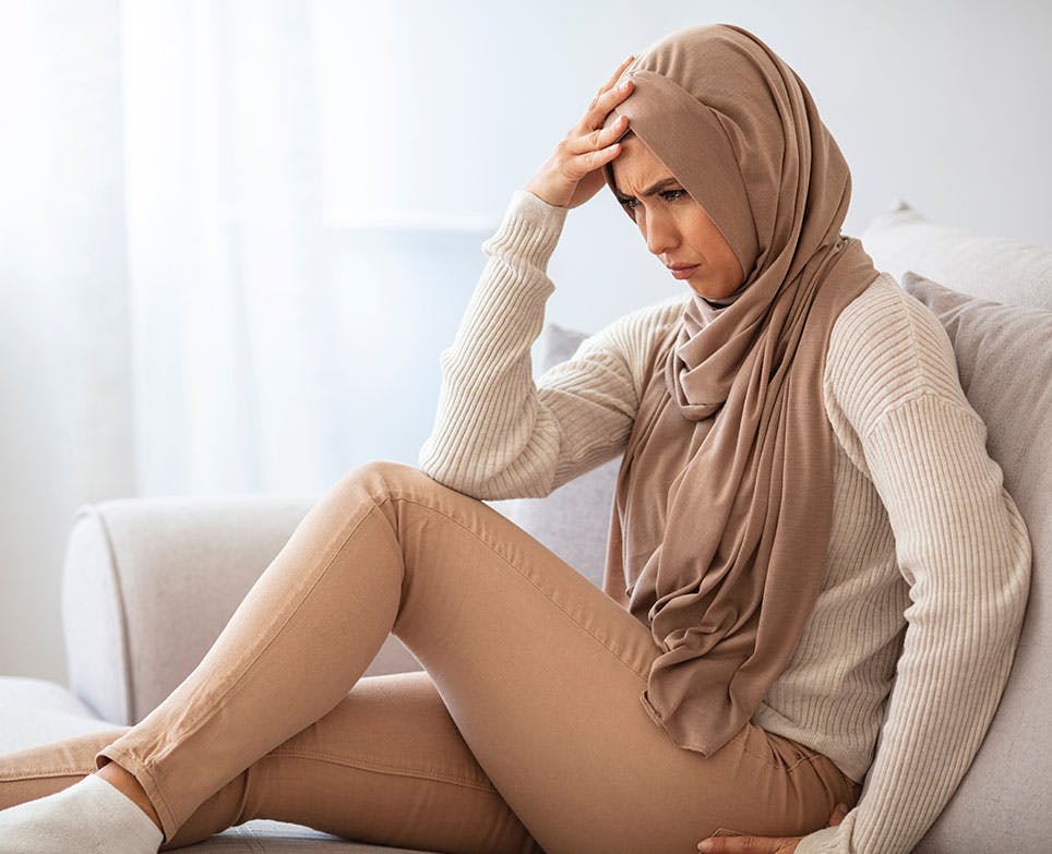 A woman at home dealing with a headache A woman at home dealing with a headache