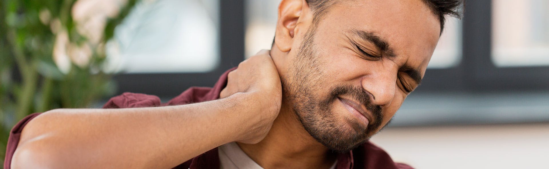 a man dealing with neck pain a man dealing with neck pain