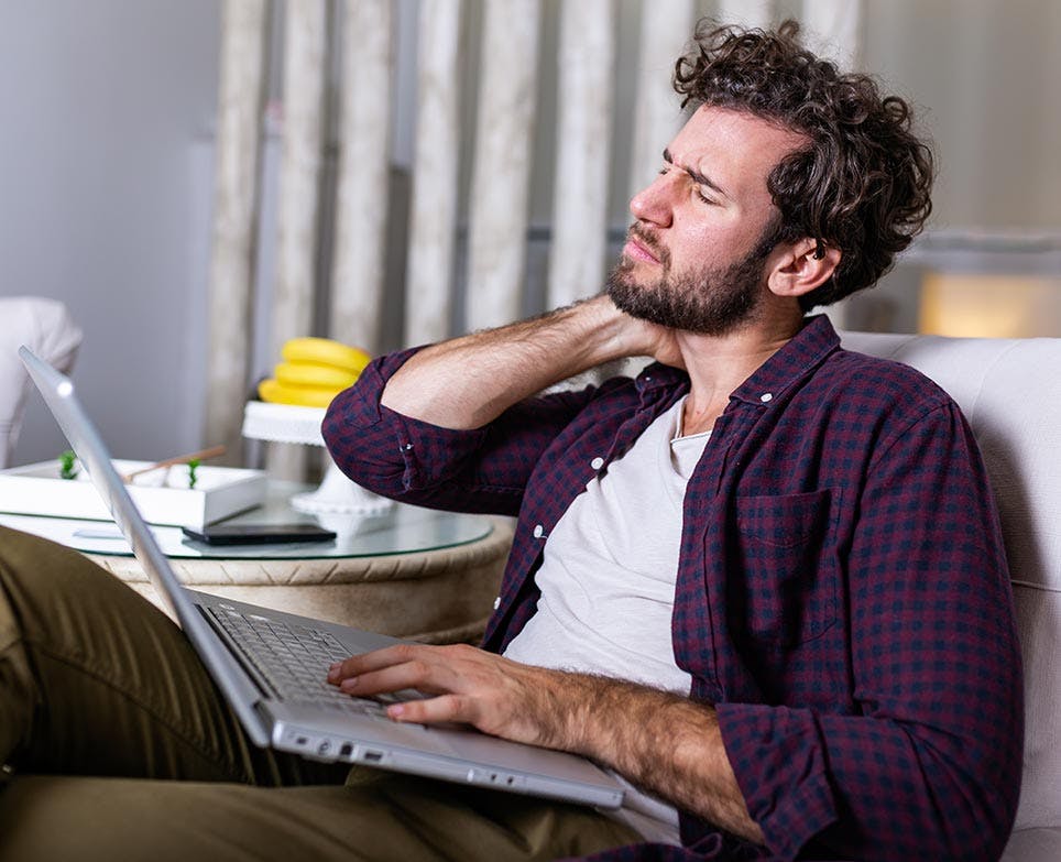 a man working and dealing with a neck pain a man working and dealing with a neck pain