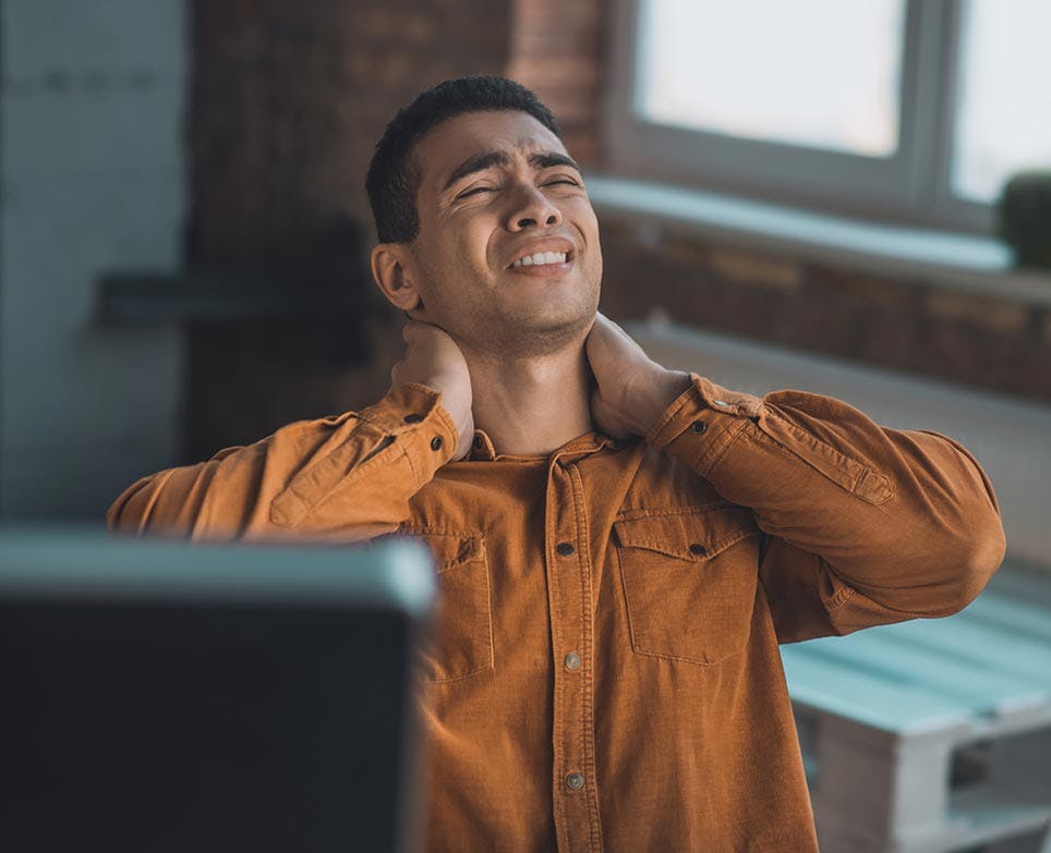 A man dealing with neck pain A man dealing with neck pain
