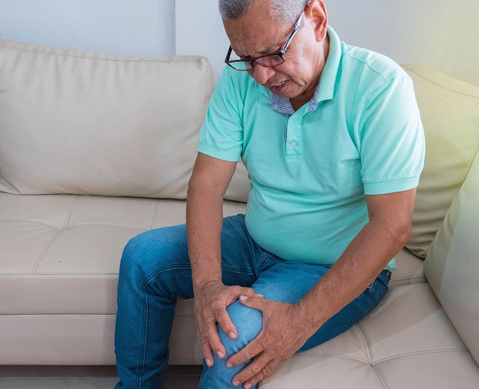 A man dealing with knee pain A man dealing with knee pain