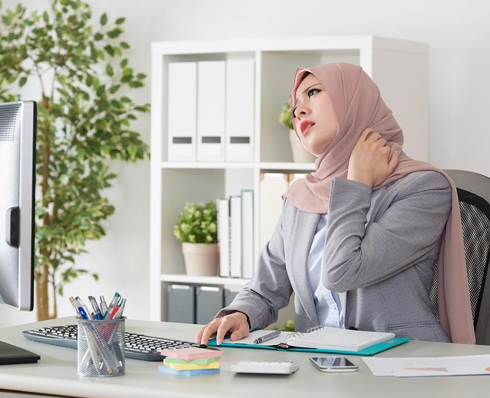 A woman dealing with neck pain A woman dealing with neck pain