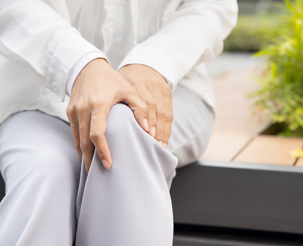 A person suffering from knee pain A person suffering from knee pain