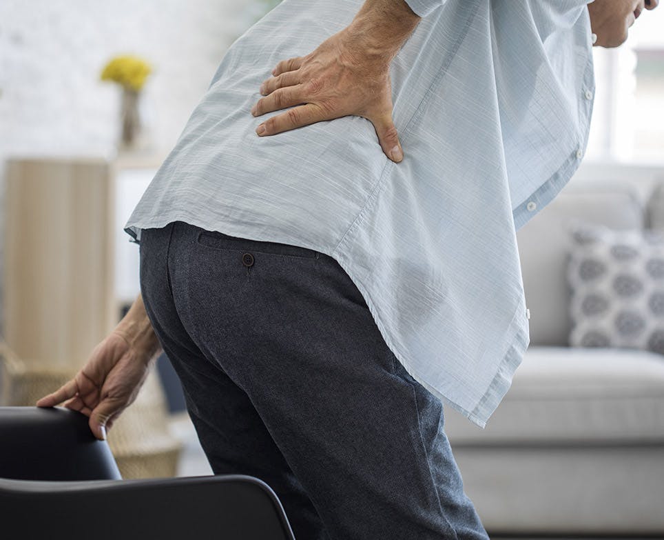 A man suffering from lower back pain A man suffering from lower back pain
