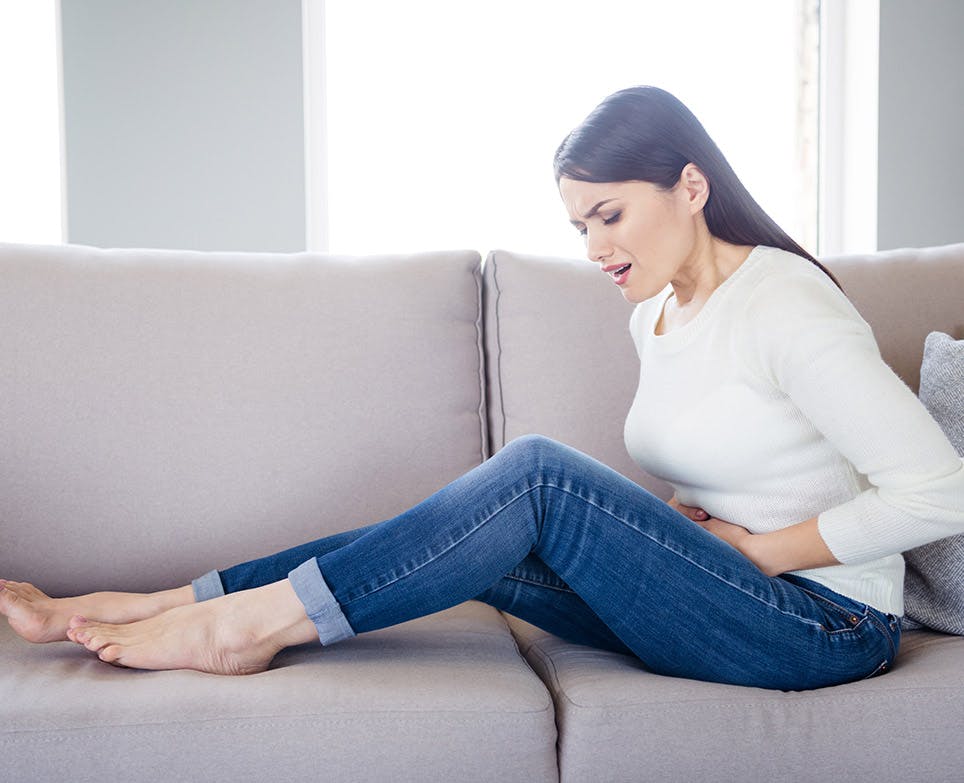 A woman dealing with menstrual cramps A woman dealing with menstrual cramps
