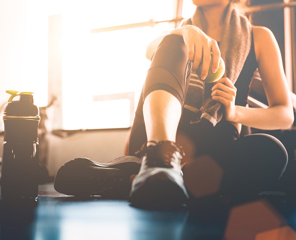 An athlete sitting on the floor. 