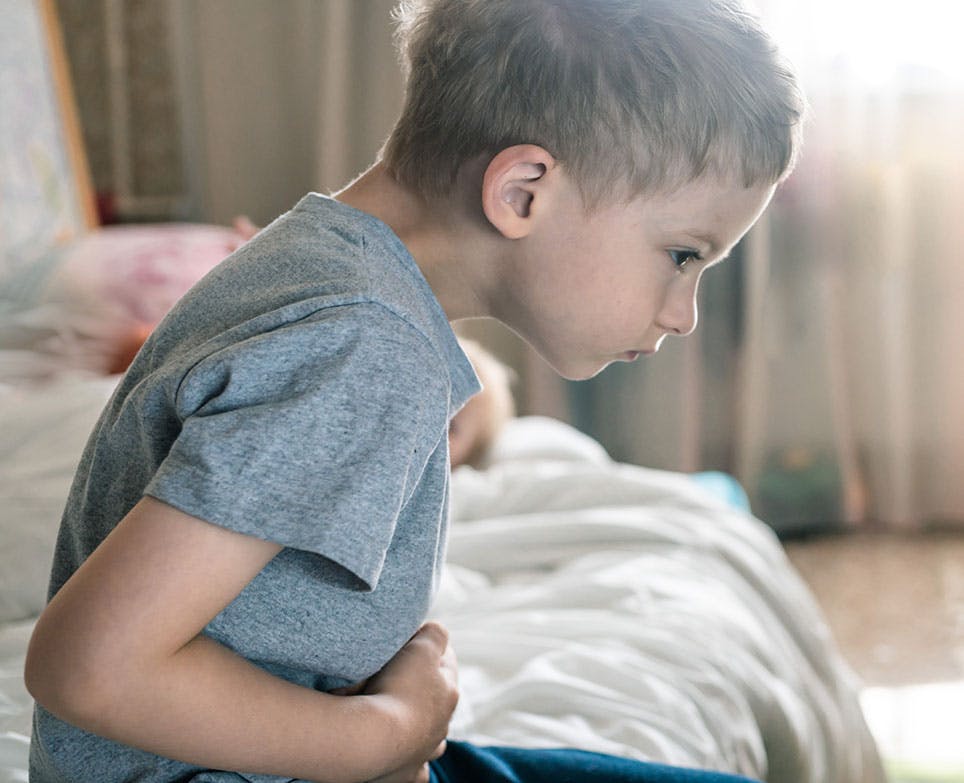 A boy suffering from a stomach ache and diarrhoea A boy suffering from a stomach ache and diarrhoea
