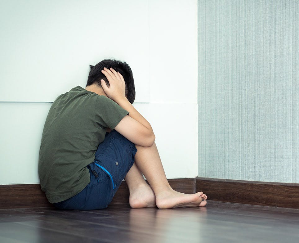 A boy suffering from an ear infection A boy suffering from an ear infection