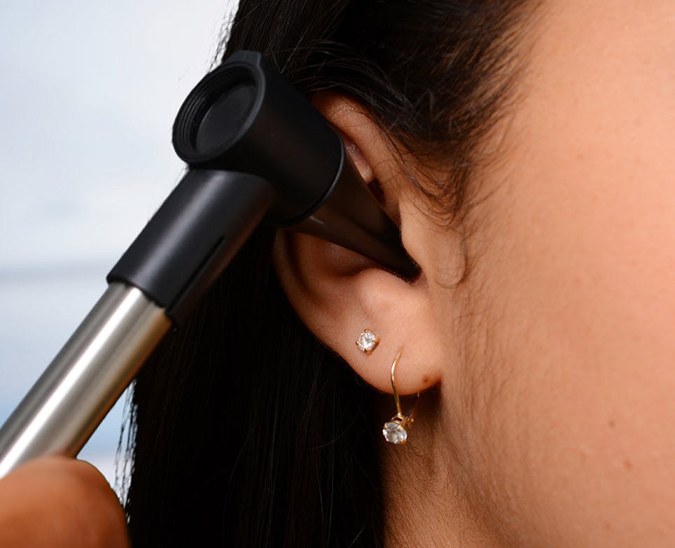 A doctor examining a child's ear A doctor examining a child's ear