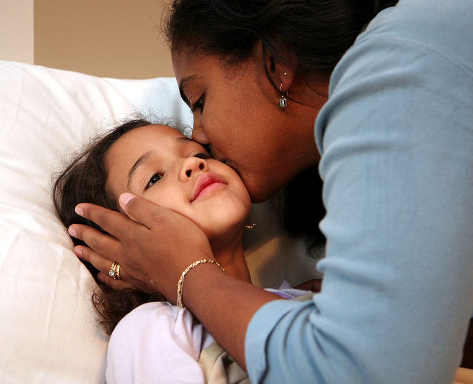 A mother kissing her daughter A mother kissing her daughter