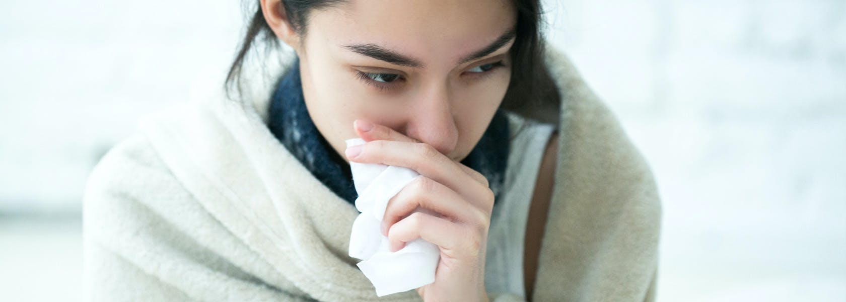 Woman blowing her nose. 