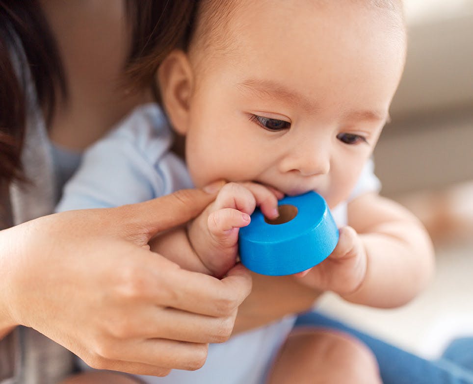 Baby biting a duct tape. 