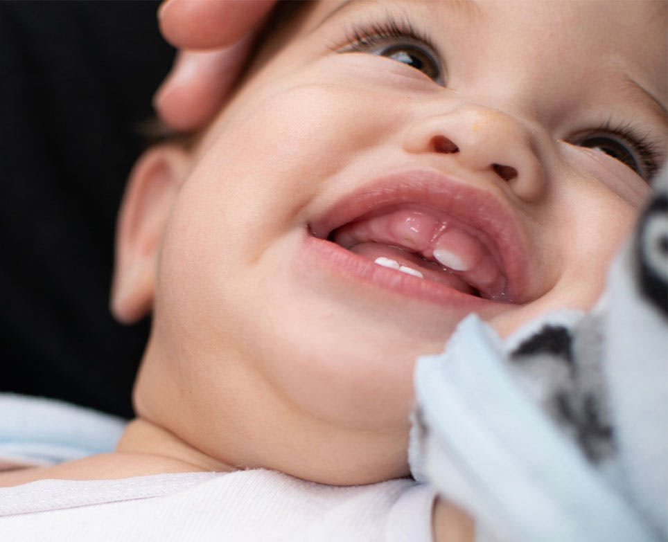 Baby smiling, in the process of teething. 