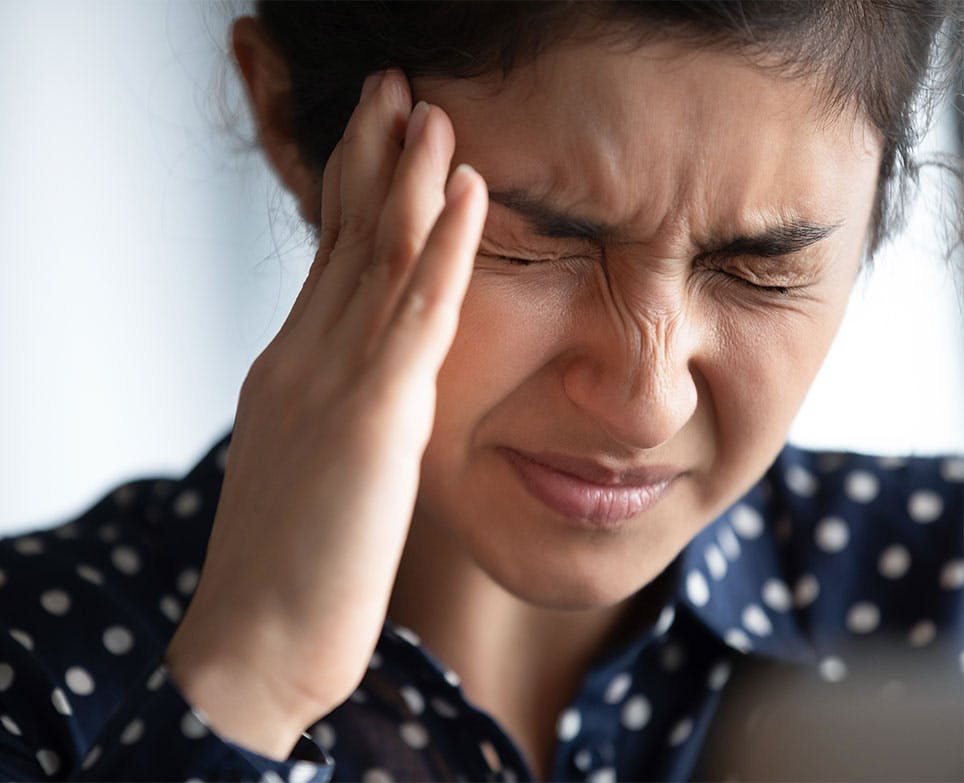 Woman holding her aching head. Woman holding her aching head.