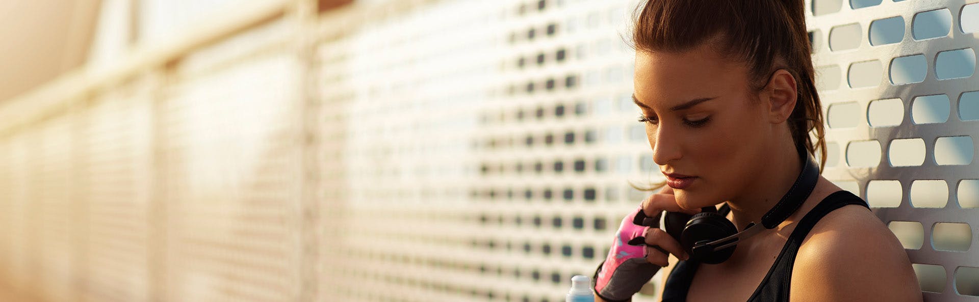 Sportswoman lying against the wall. 