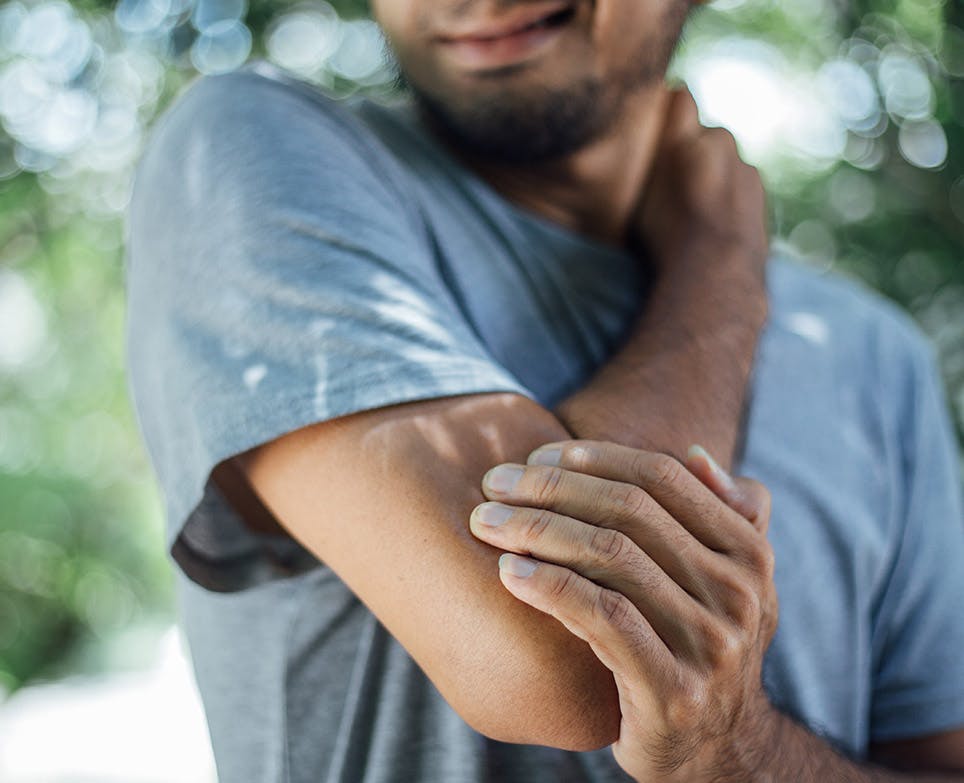 Man holding his hurt elbow. Man holding his hurt elbow.