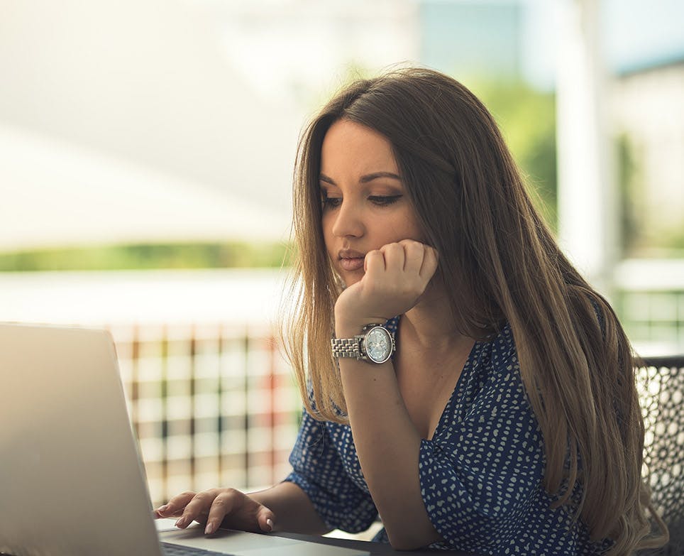 Woman working in front of the laptop. 