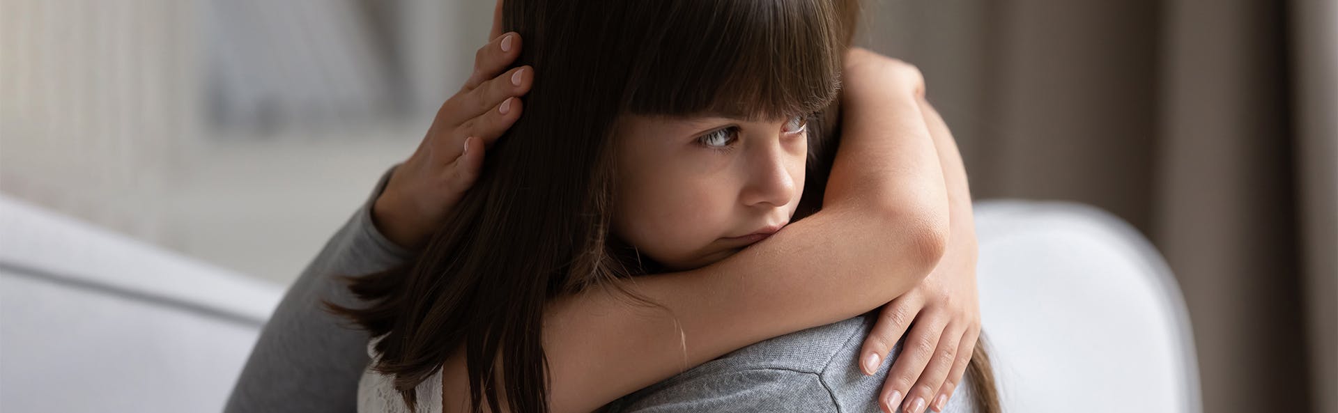 Mother hugging her sick daughter. 