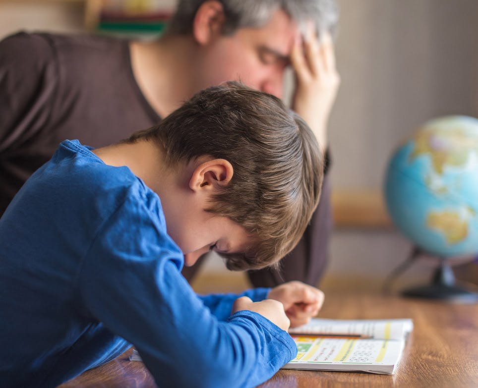 Child studying while suffers for a headache. 