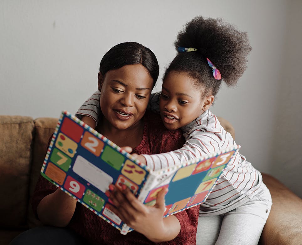 Mother and daughter reading a book