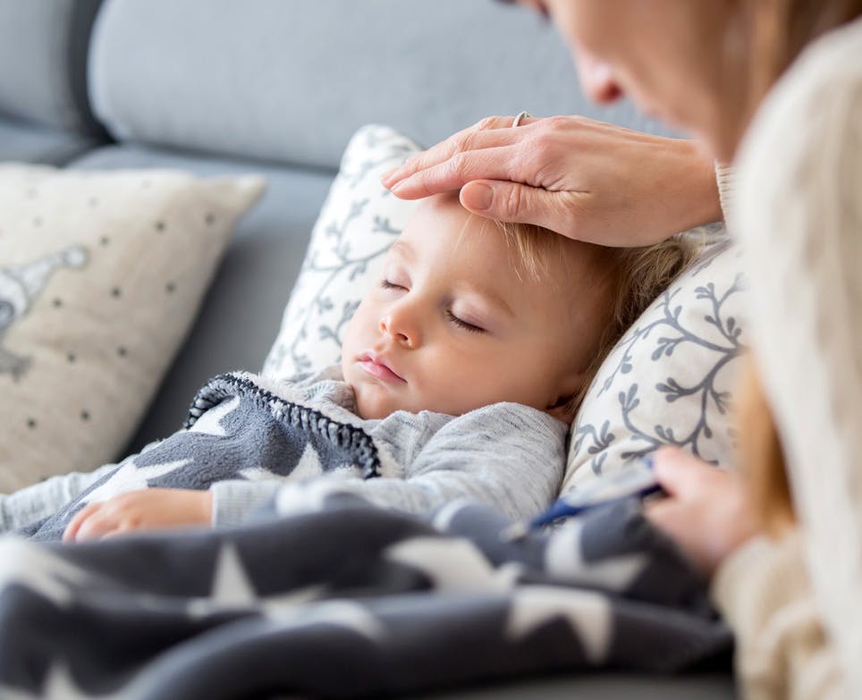 Mother checking son's temperature