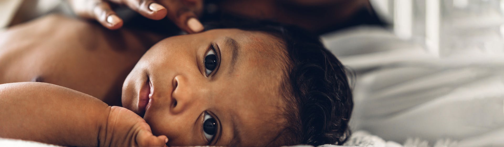 Mother touching baby's head