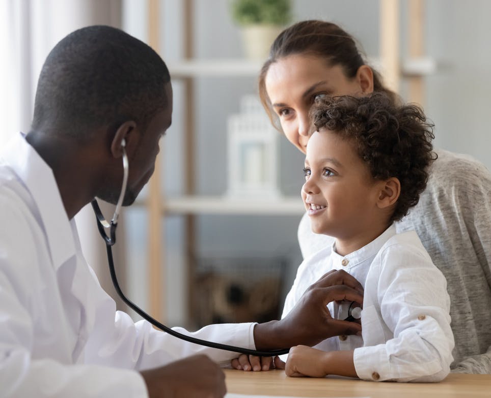 Doctor listening to a child's heartbeat