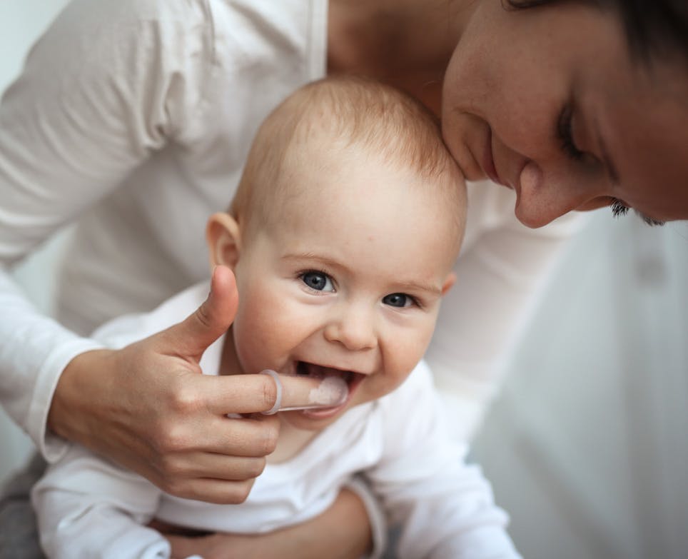 Mother brushes her teeth with a special nozzle