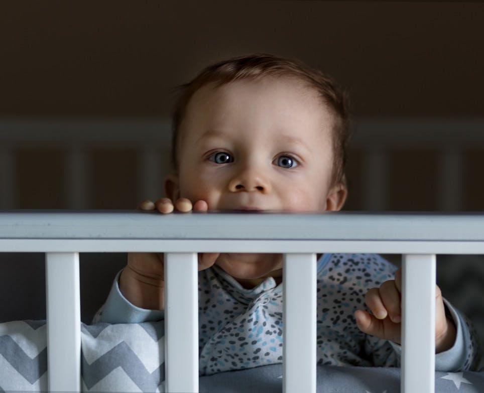 Baby chewing cot side