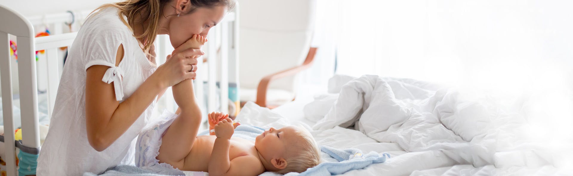 Mother changing baby's diaper