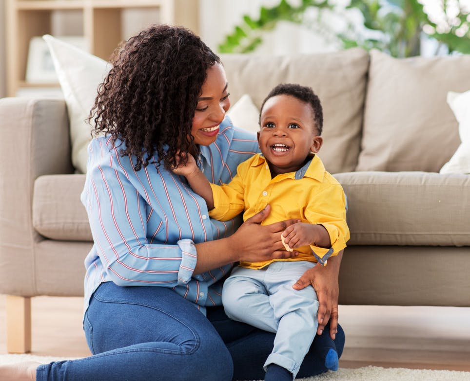 Woman and her child sitting on the floor