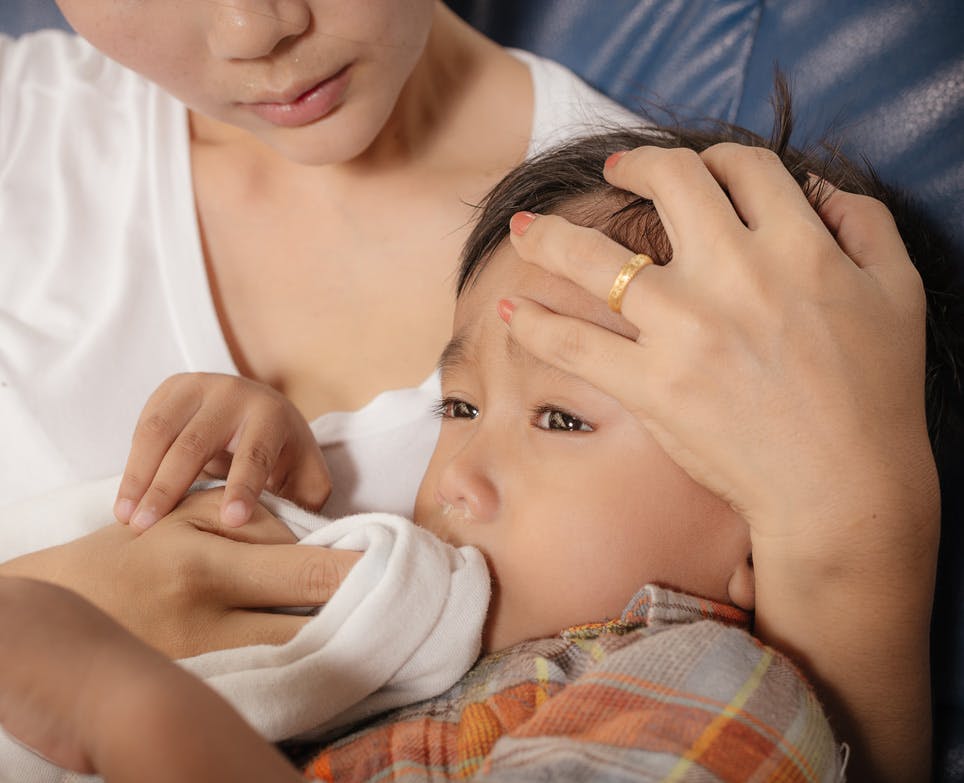 Mother looking after her sick child